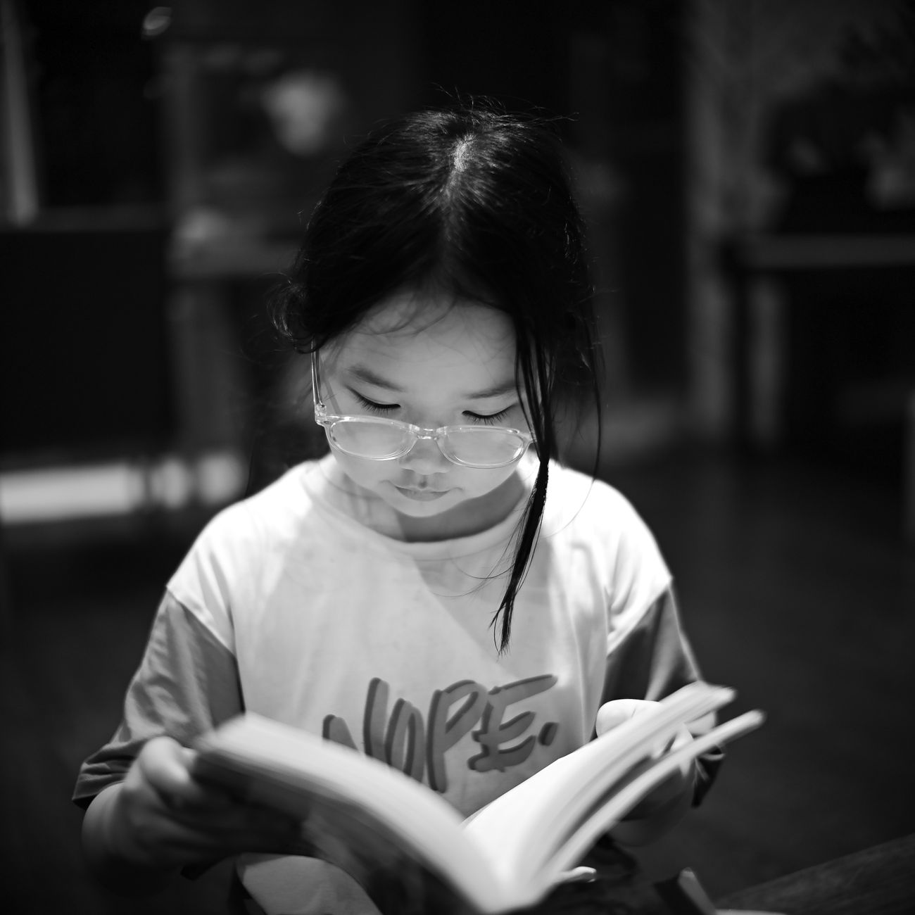 Young child reading a storybook quietly indoors