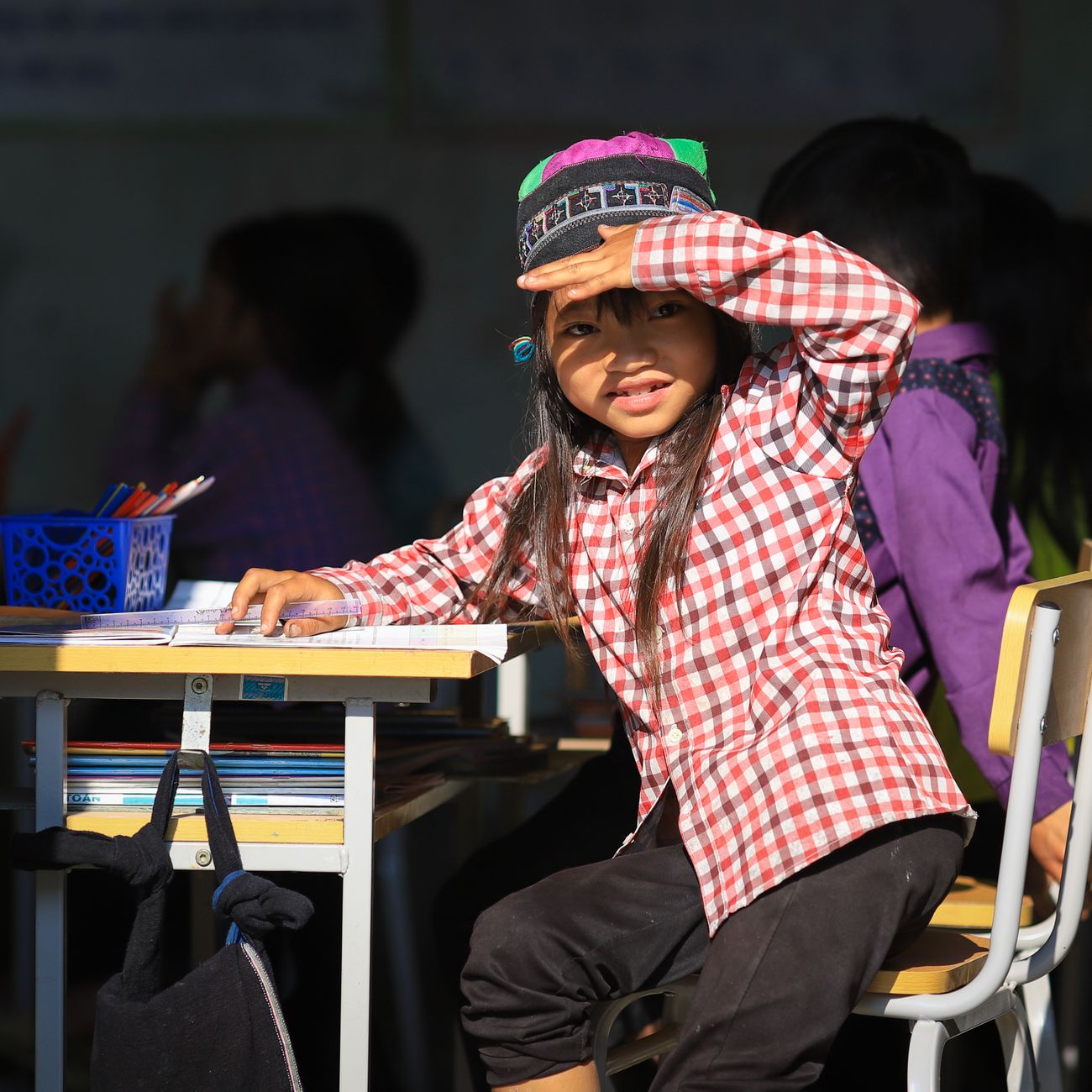 Preschool child engaged in a classroom activity with school supplies